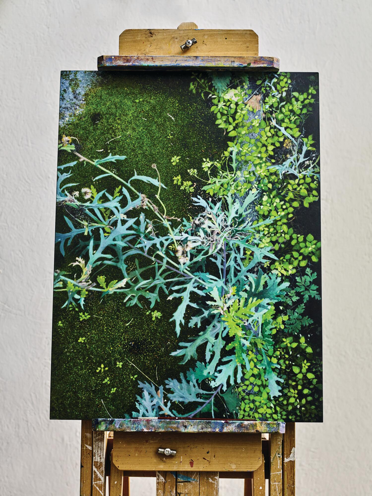 Green plants in a painting on an easel