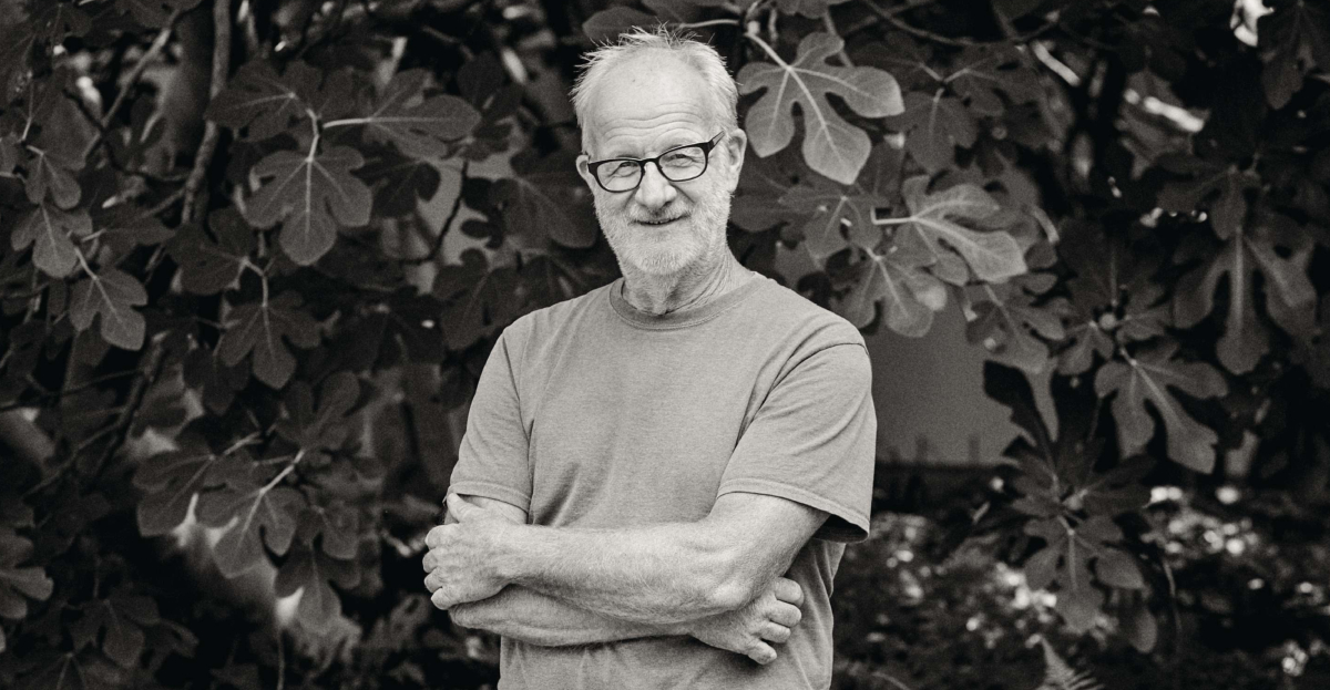 Black and white portrait of man stood in garden