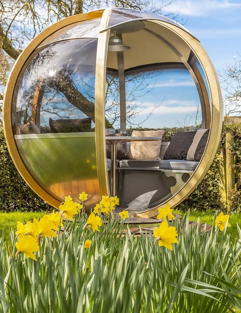 Ornate Garden Luxury Rotating Pod among daffodils