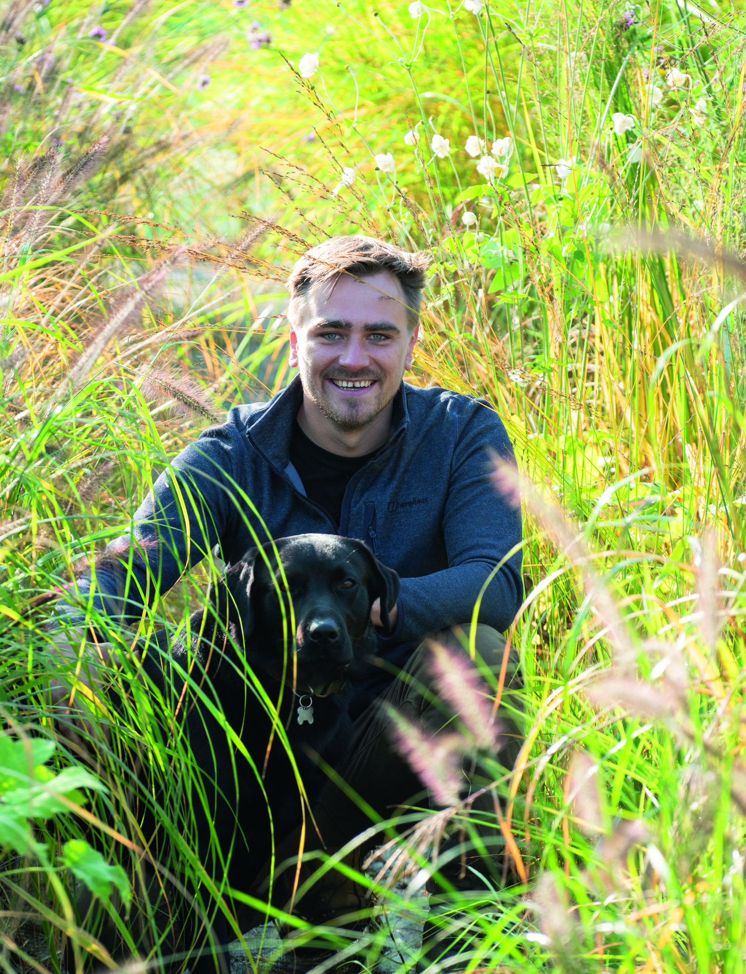 Man in grass with dog