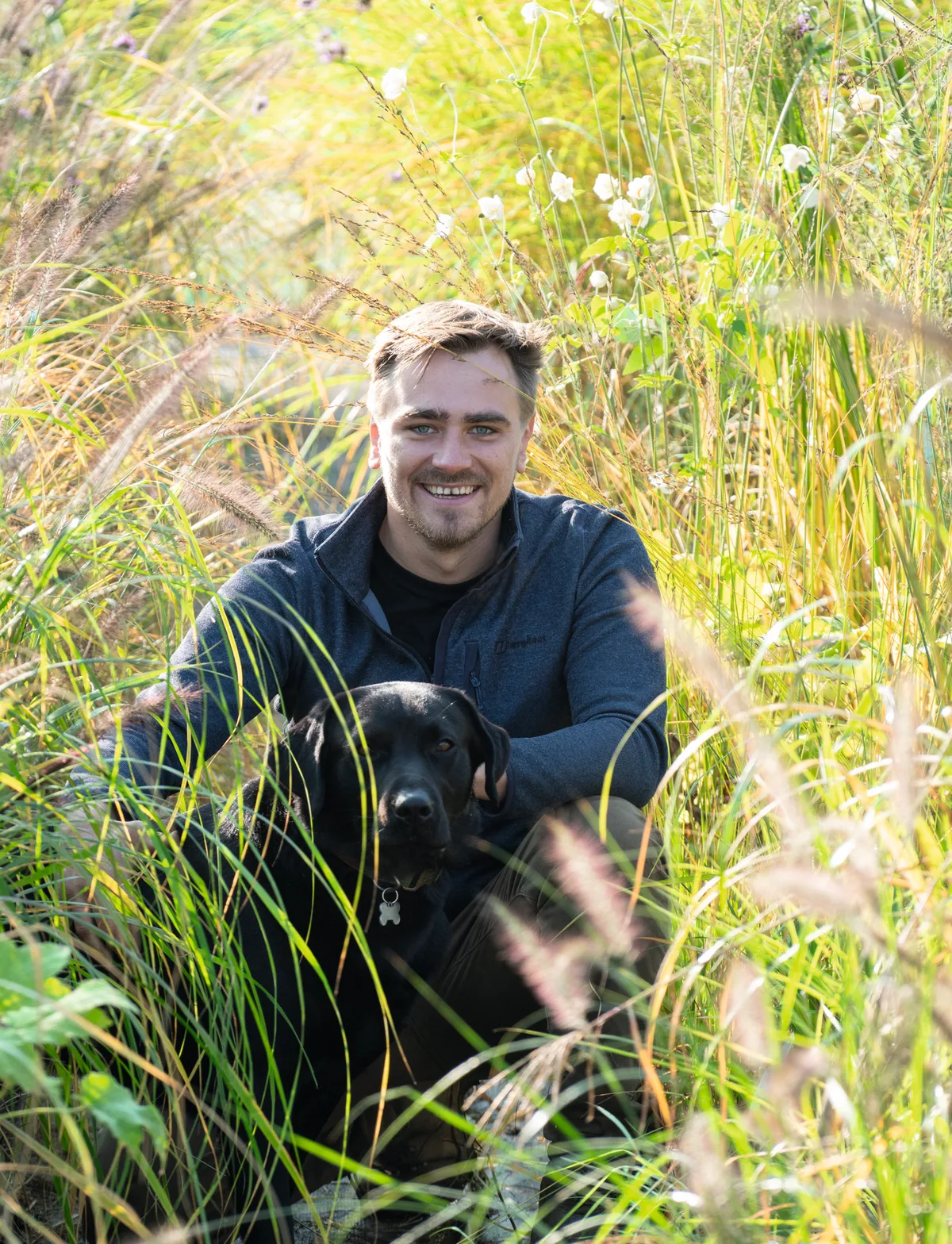 Man in grass with dog