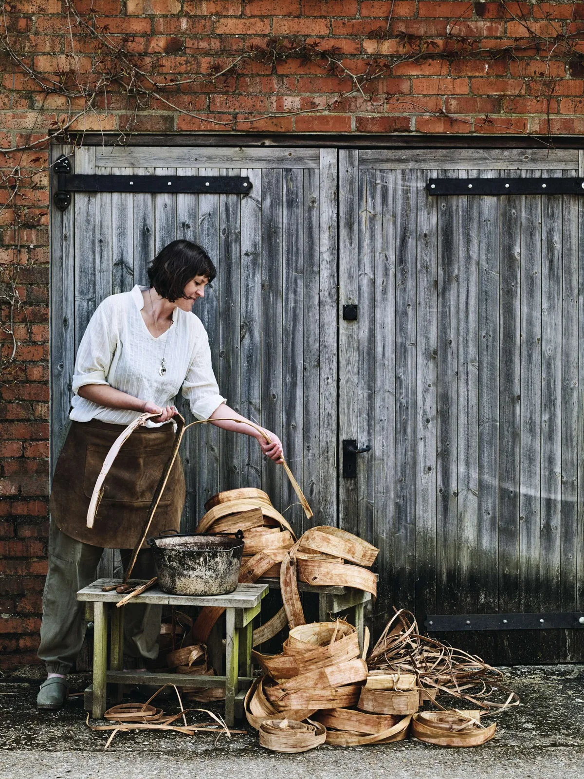 Mollie McMillen harvests western red cedar (Thuja plicata) bark from felled, plantation-grown trees.