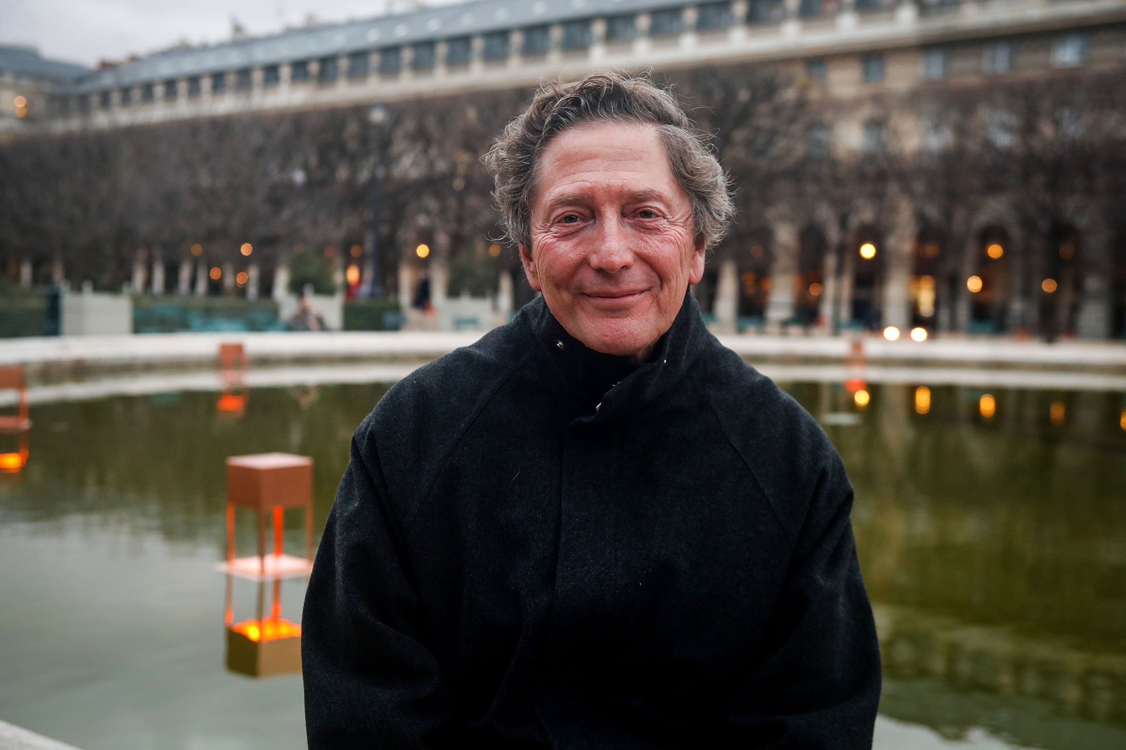 Spanish artist, landscape designer and philosopher, Fernando Caruncho at the Garden of Palais-Royal illuminated by his art installation.