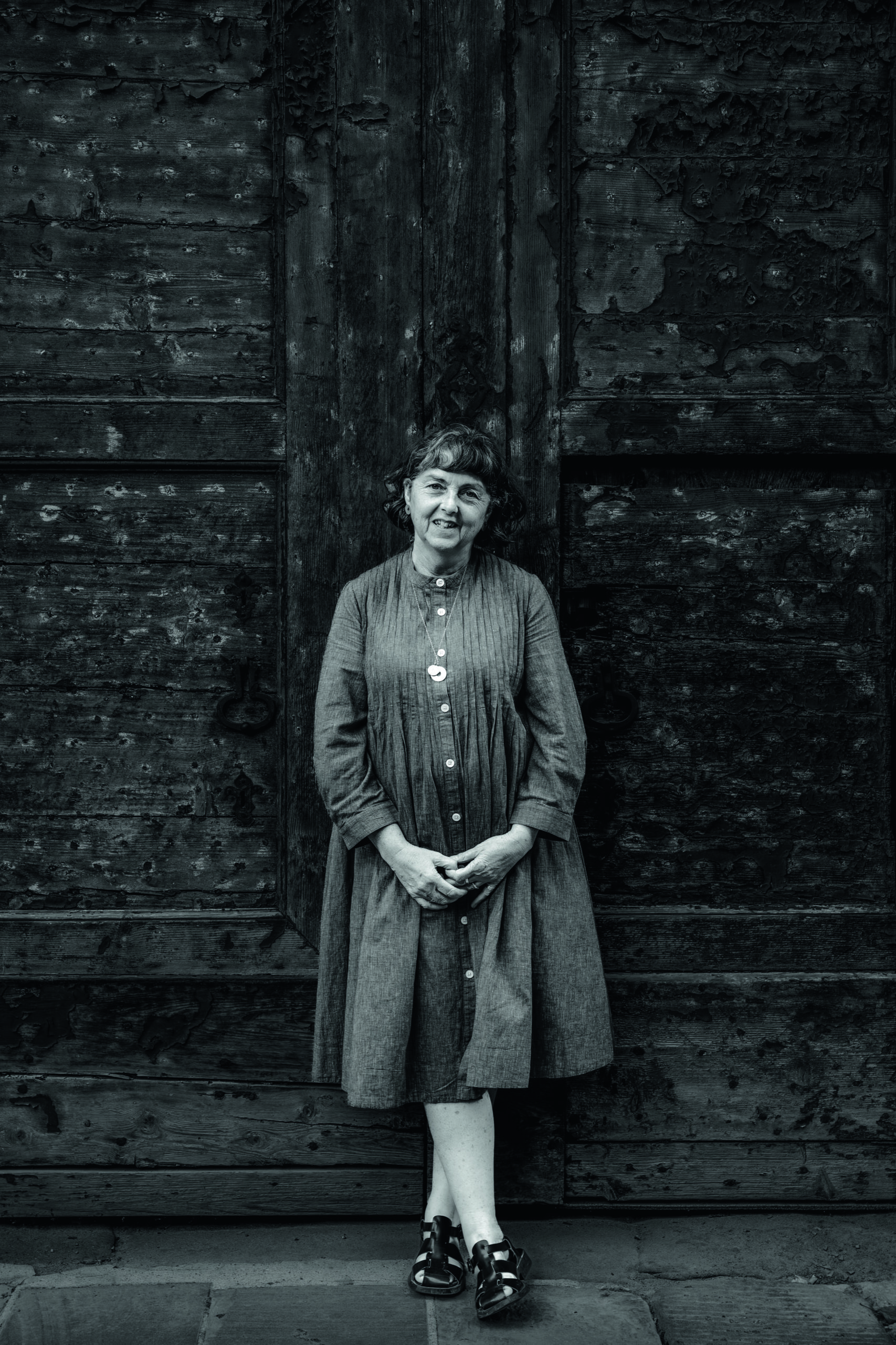 Woman stood in front of a wooden door