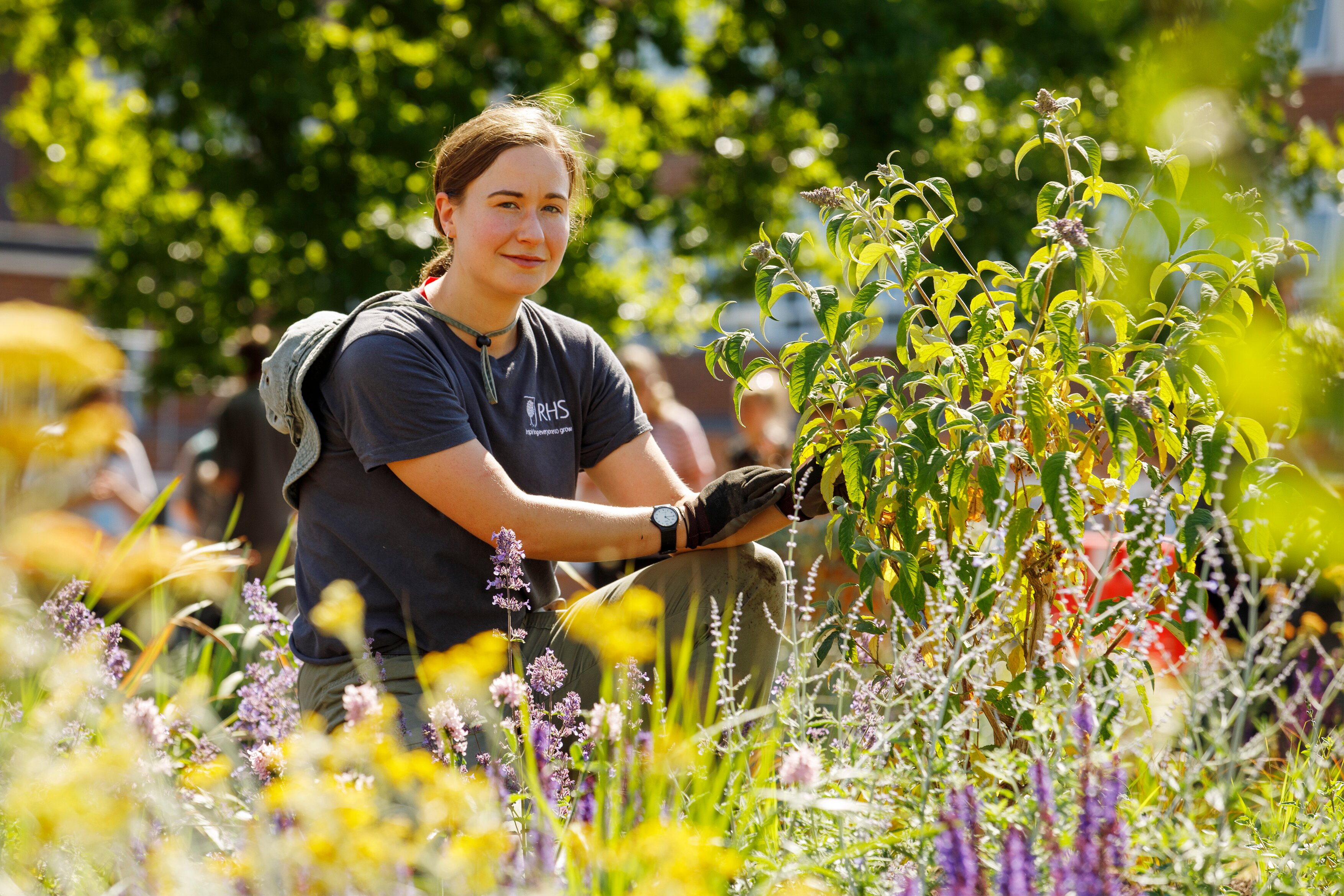 Horticulture student Emma Leaper poses in the garden she designed for the Kings College